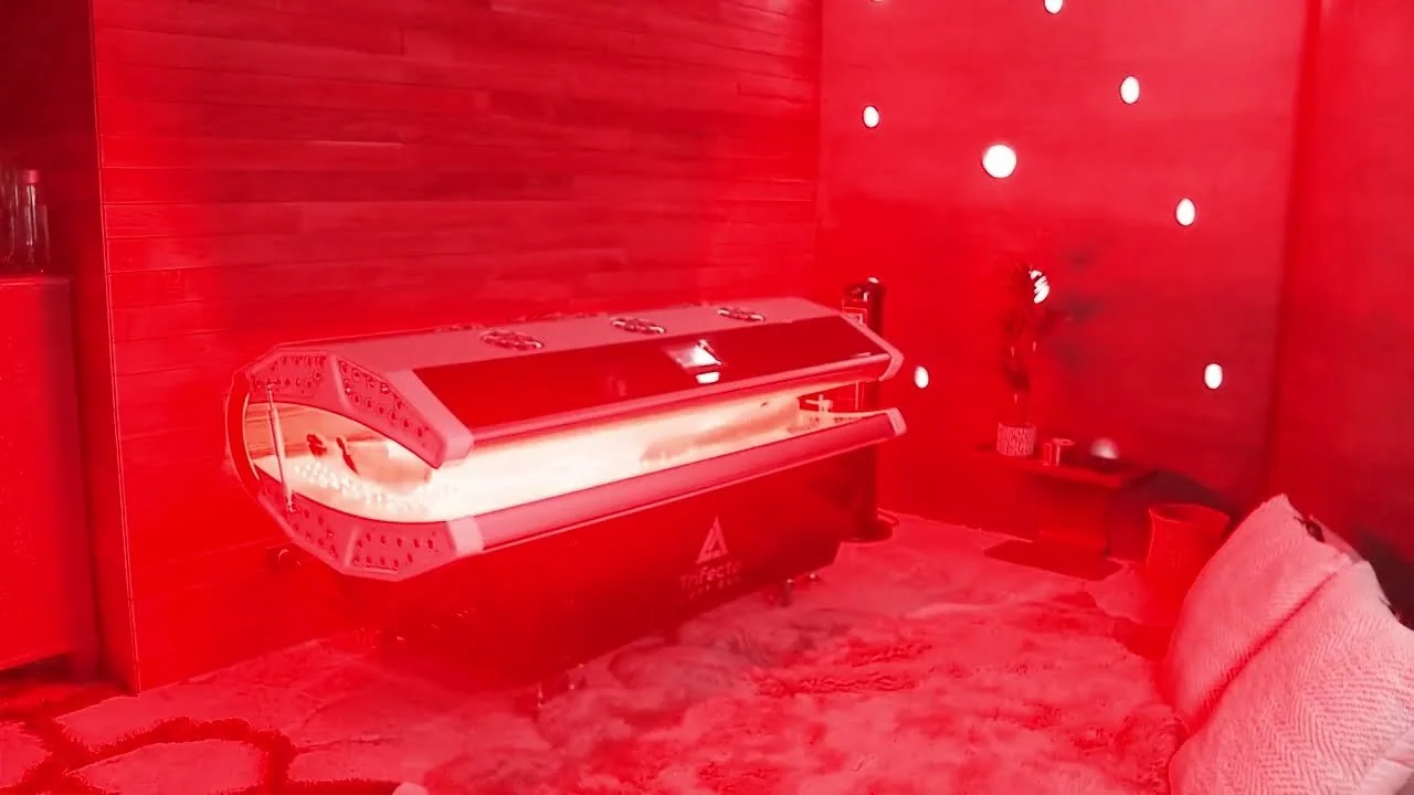 Trifecta red light therapy bed glowing in a treatment room